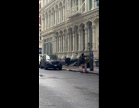 Man wears black jacket stretches on sidewalk part 2