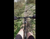 Guy on bicycle jumps small hill fail 
