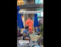 Guy wears jail jumpsuit costume on street