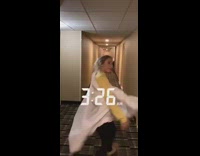 girls walking down hotel hallway one falls