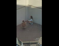 Girl grey skirt kneel pose beside wall