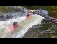 Man and kid swim on river natural whirlpool