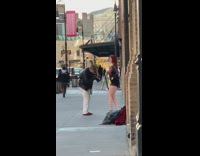 Girl tap dances black shoes sidewalk guy