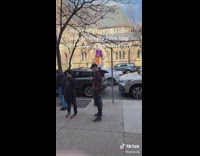 Guy walking with brown nike bag line of people