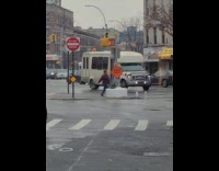 Woman filming dance in middle of street