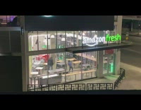 Man in a blue shirt dances inside the store