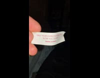 Dog eats fortune cookie paper while guy reads it 