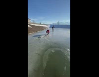 Guy slips on ice and it breaks as he runs