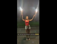 Girl red shirt dancing with firework sparklers drops firework slow motion
