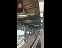 Man moves his hips in a circle at train station