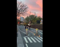 Man ride bike while rolling luggage street