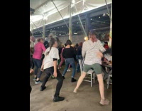 People Dance as Music Plays in Food Park