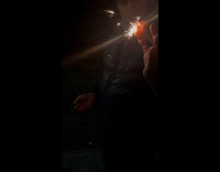 Guy puts sparkler on clementine lights inside