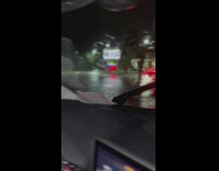 Gar stuck past guard rail in rain and flood 