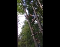 shirtless man black shorts rope swing back flip