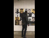 Guy leather jacket talks to pictures on movie posters in subway train