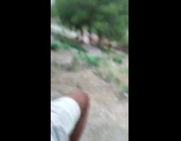 Woman in crop top attempts to do the dancer's pose at the park