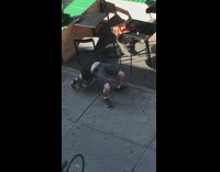 Guy stretches his back on the ground near Starbucks 