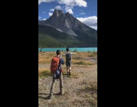 Guy grey sleeves walk arms stretched lake