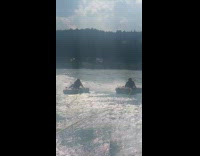 Men water tubing inflatable lands on the other 