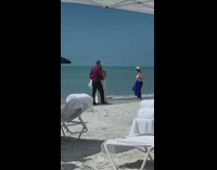 woman in wedding dress on beach man