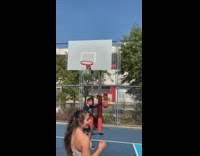 Double jointed guy shoots and makes basketball with arm bent behind head