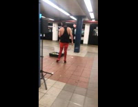 Guy wears red boots at subway station 