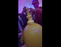 Guy at music rave stacks a bunch of ducks on top of each other