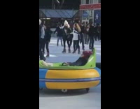 Girl spins around in tube on wheels 