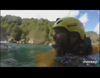 Yellow jacket helmet guy swims lake water
