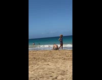 Woman curly hair foot being filmed beach