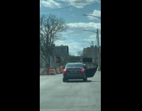 Car drives with door open big box