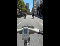 Man riding giraffe unicycle on street