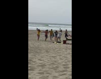 Five people dance exercise with music at the beach