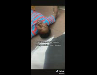 Man approaches girl while laying on floor