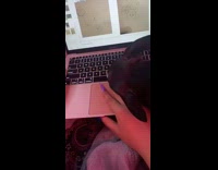 Dog forces head under hand girl laptop 