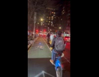 Man rides bicycle hold bouquet of flowers