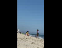 Three girls take turns taking photos beach 