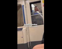 Man smiling and screaming through subway window