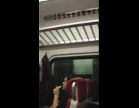 Woman eats string cheese by biting it on metro train