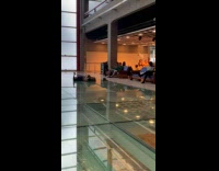 Collab IITW - Woman in blue top and skirt lie down on the glass floor 