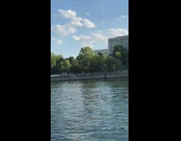 Lady dances platform edge river straw hat