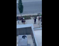 Collab IITW - Man with two women twerks on sidewalk