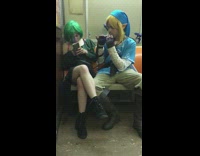 girl green hair guy dressed as elf playing flute 