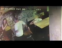 Two men white shirt weird table CCTV
