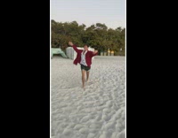 Guy runs to friends on sand trips face first 