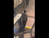 Man grey jacket walk wrong way escalator