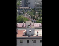 Woman bikini hold cloth building rooftop windy