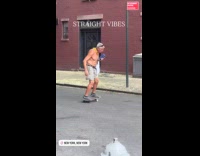Shirtless elderly man skateboarding on street