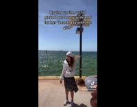 Guy pretending to hype up girlfriend in white dress 